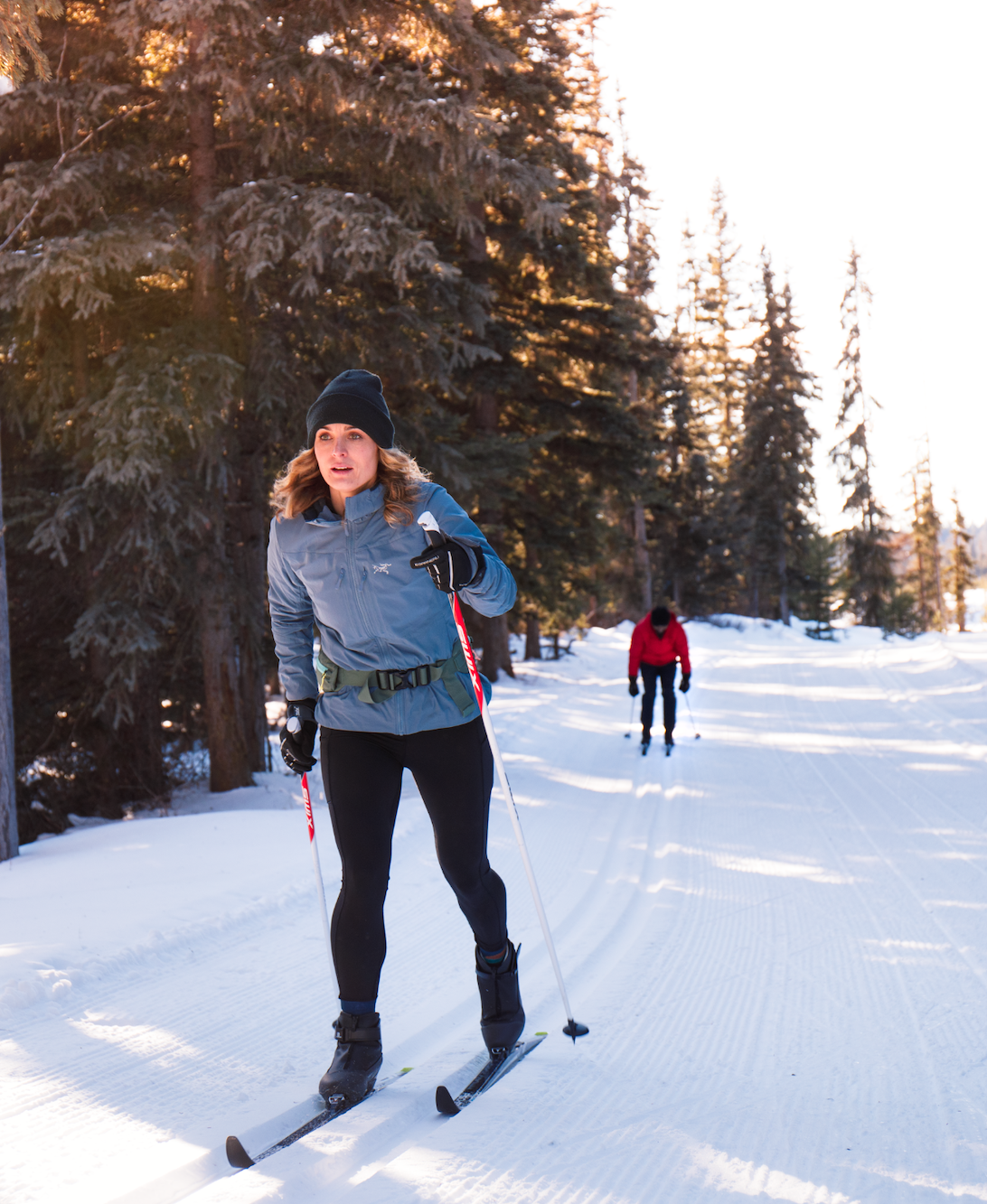 Cross country skiers gliding along the groomed trails at Stake Lake with Overlander Ski Club near Kamloops, BC.