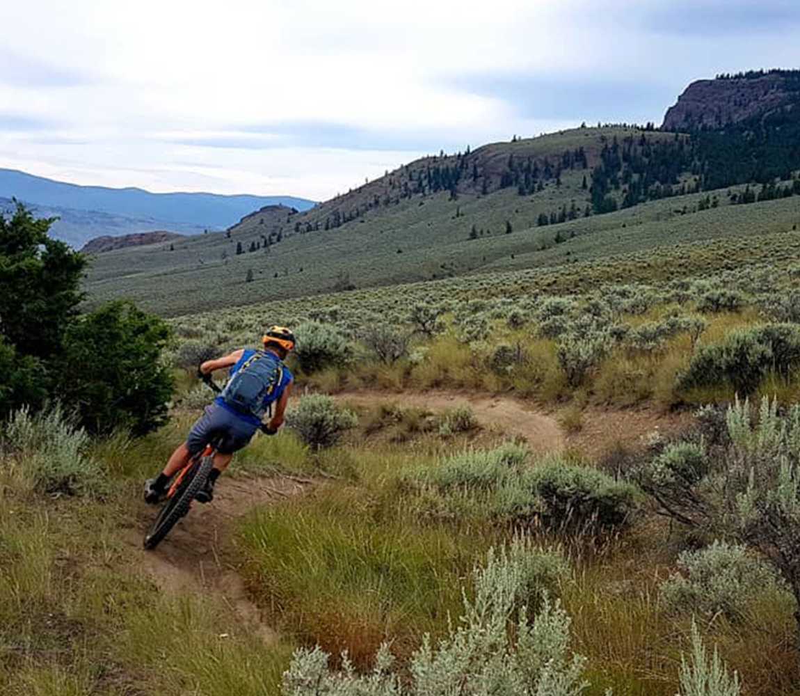Solo person mountain biking in the Lac du Bois Grasslands in Kamloops, BC