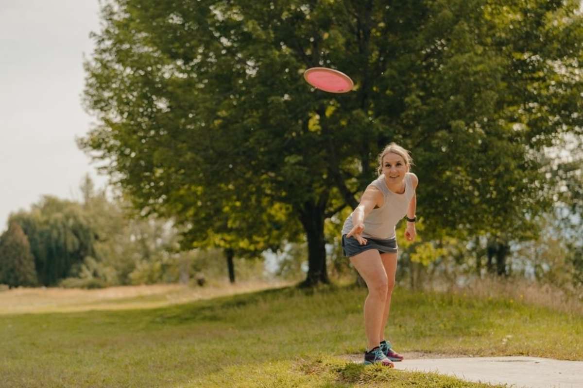 Woman disc golfing at McArthur Island