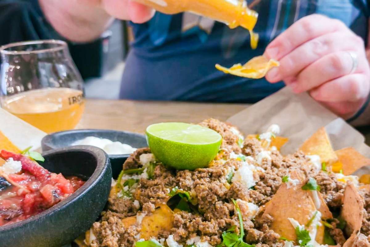 Beth and Oliver eating nachos at Iron Road Brewing