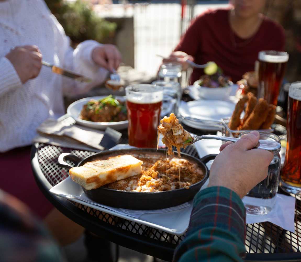 A group enjoying beer and food on the Noble Pig Patio located in downtown Kamloops, British Columbia.