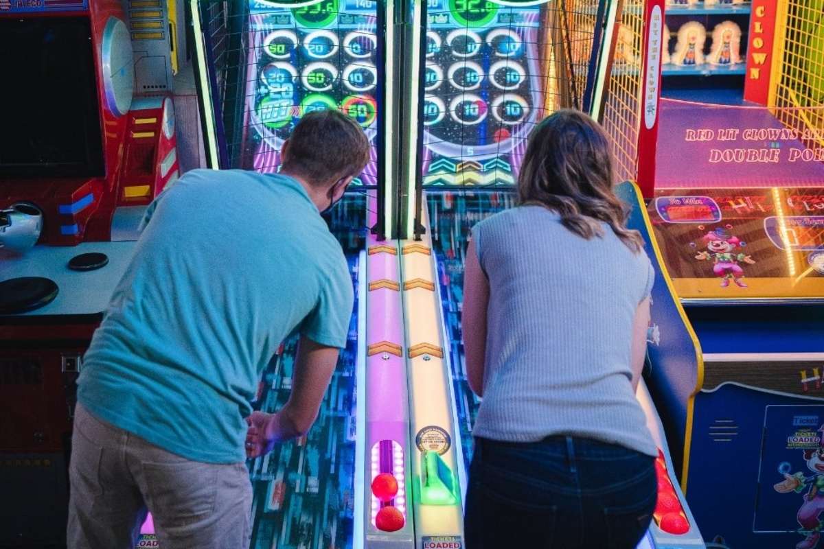 Couple playing skeeball at an arcade in Kamloops