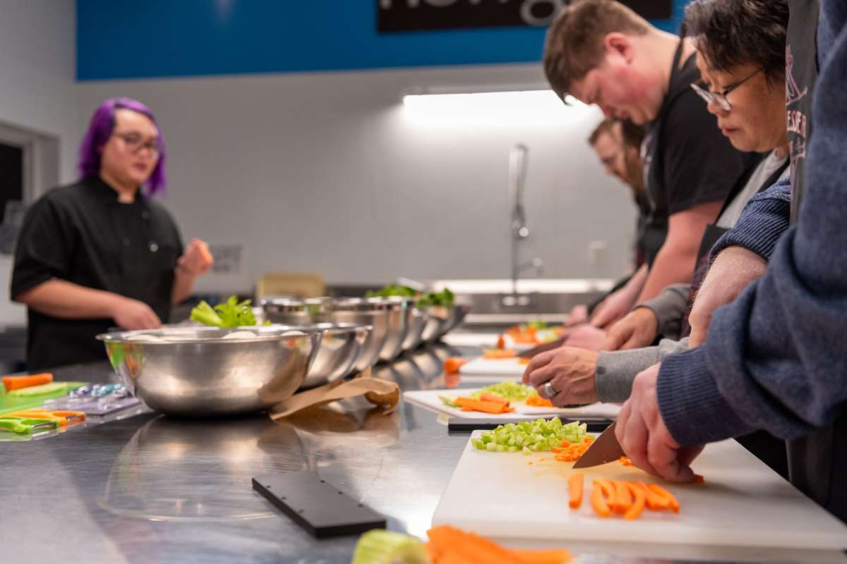 Students learning at a Kuzina Messer Culinaire cooking class in Kamloops, BC.