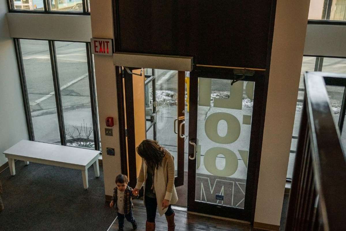 mom and son walking into a museum