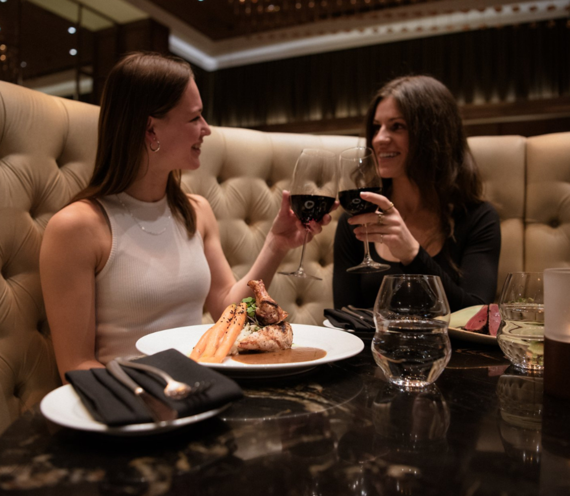 Two Women enjoying their meal at Atlas Steak + Fish in Kamloops, BC