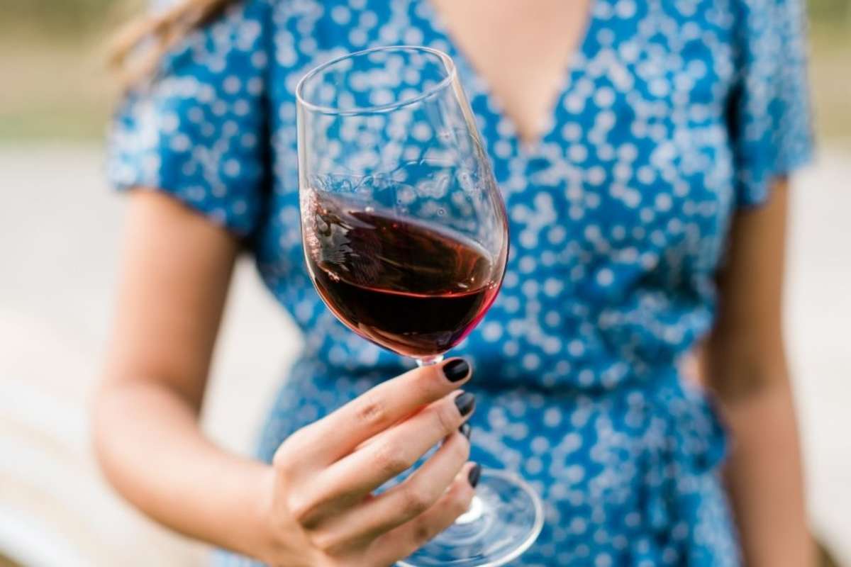 An individual swirling a glass of wine