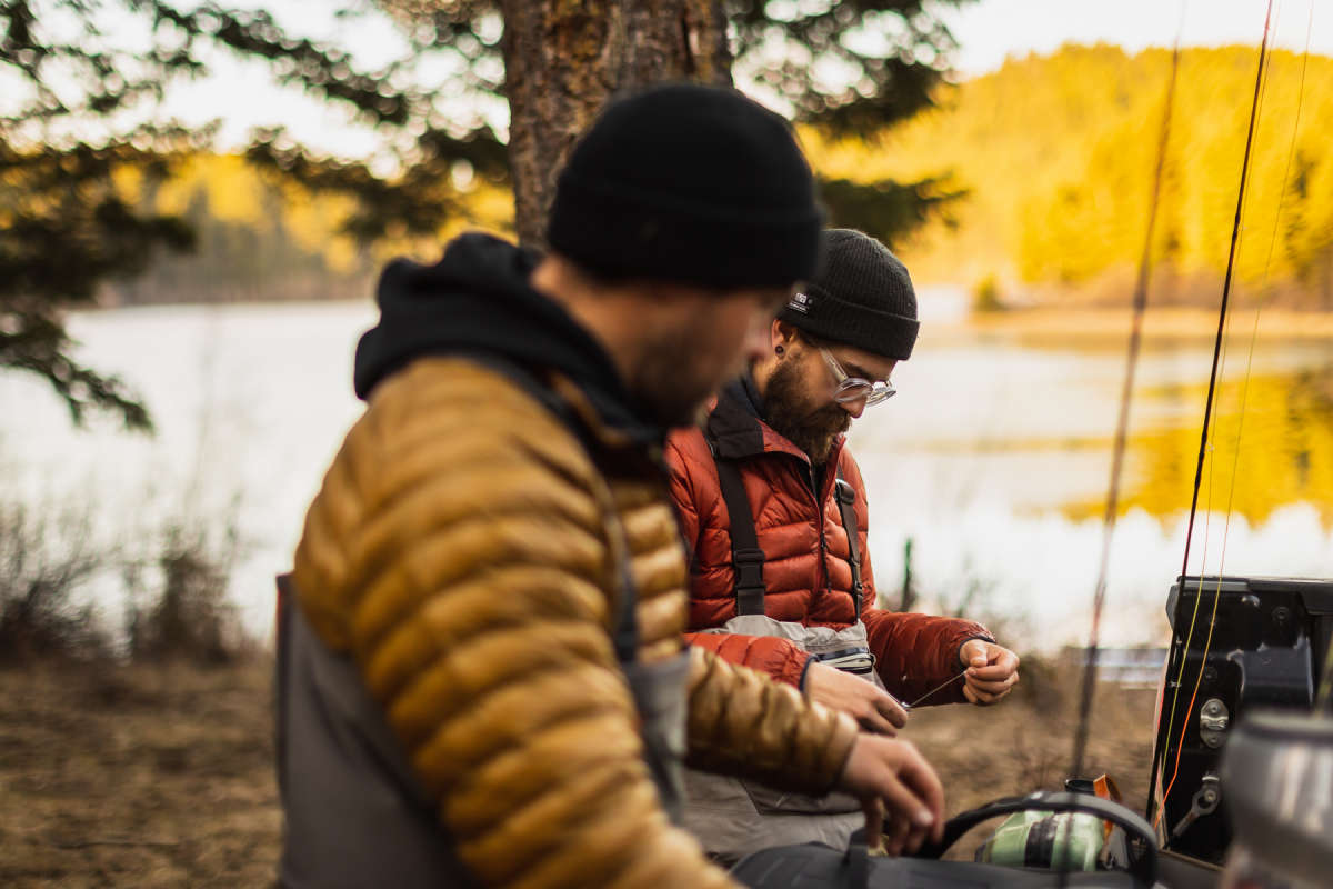 Two men preparing their tackle for ice off fishing in Kamloops, BC.