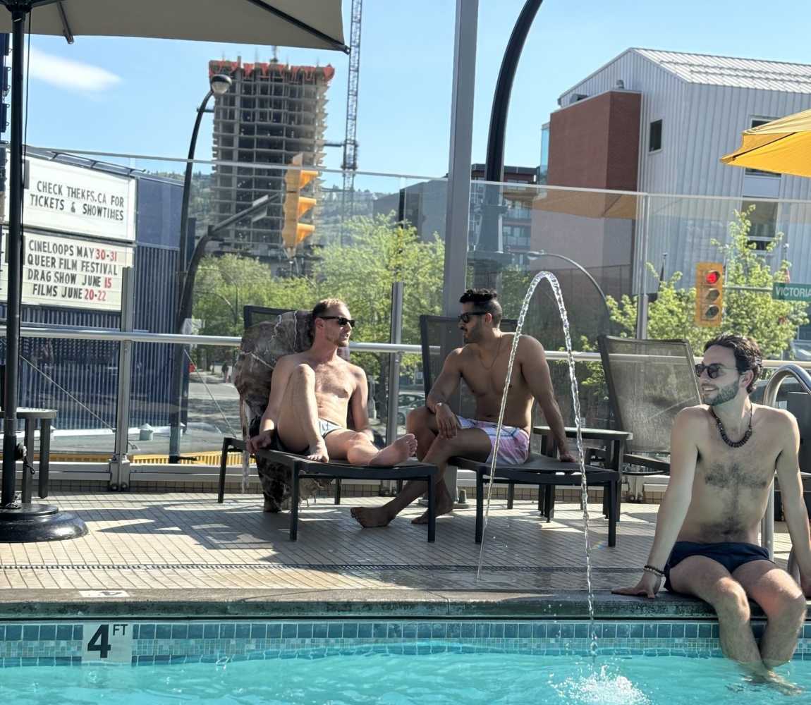 Three men enjoying the pool at the Delta Hotel in Kamloops, British Columbia