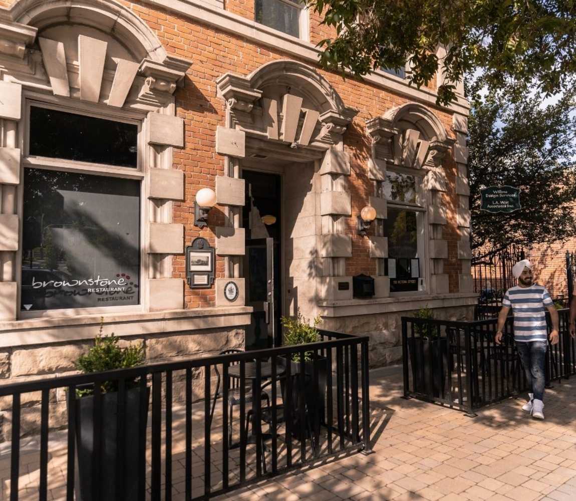 person walking down the street outside Brownstone Restaurant