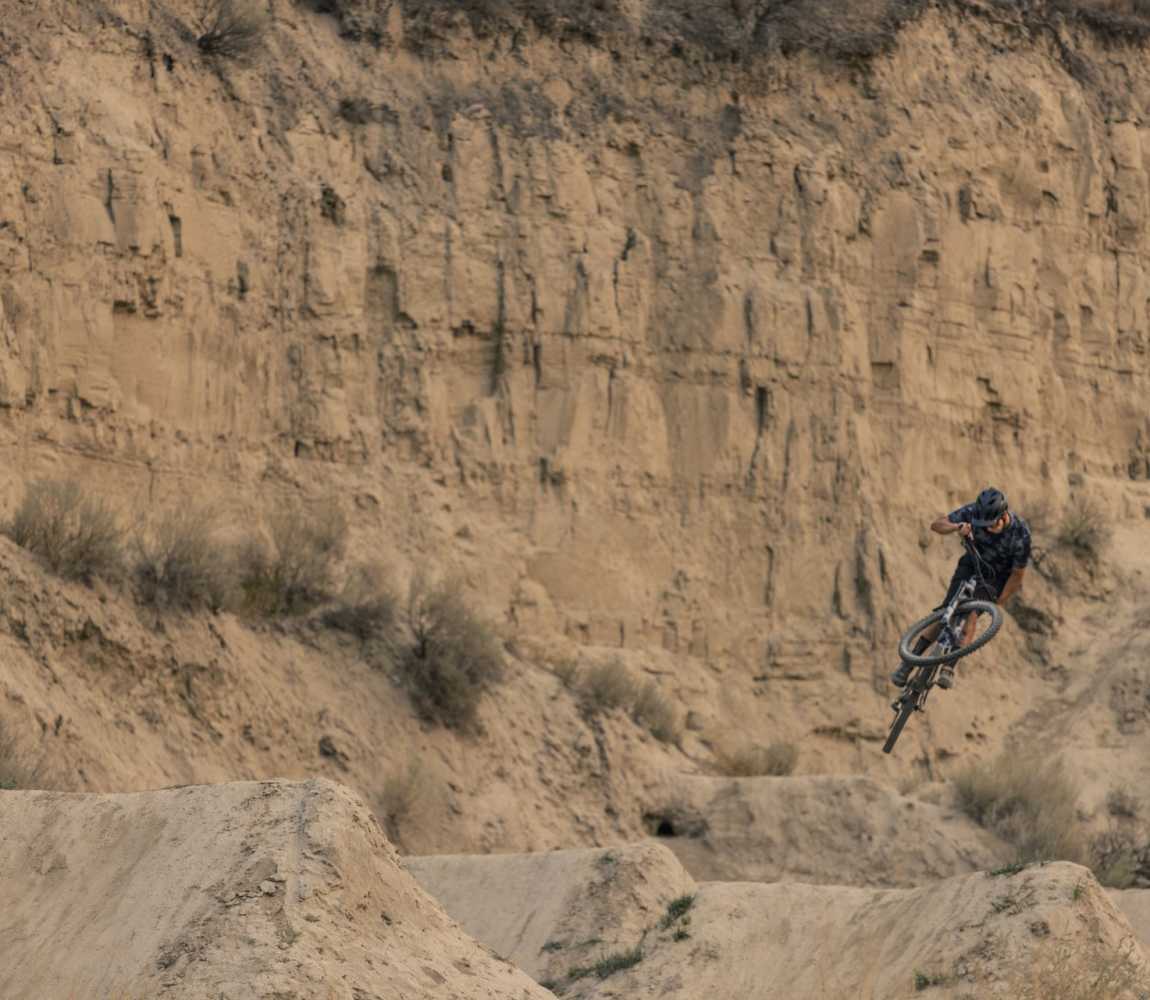 Mountain Bike Rider getting air in the jump park at the Kamloops Bike Ranch, located in the Thompson Valley, British Columbia.