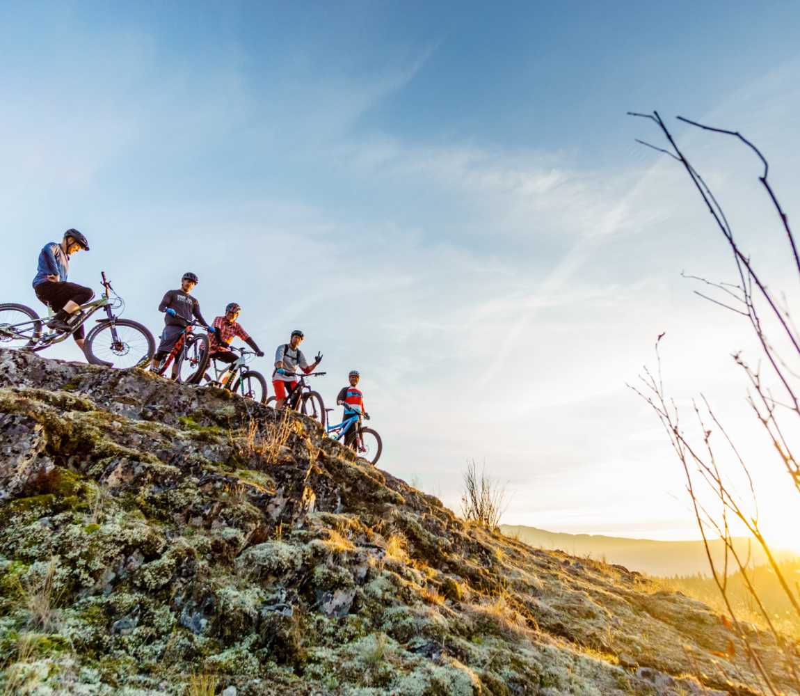 Group of mountain bikers ontop a hill in Pineview mountain biking network in Kamloops, BC.