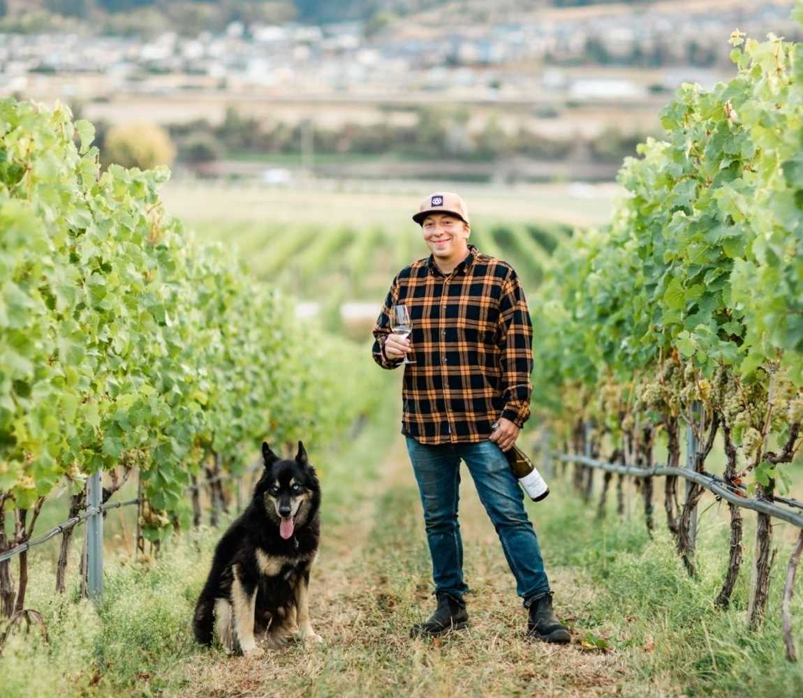 Winemaker, Sebastian Hotte, and his dog in the vineyards at Harper's Trail Winery