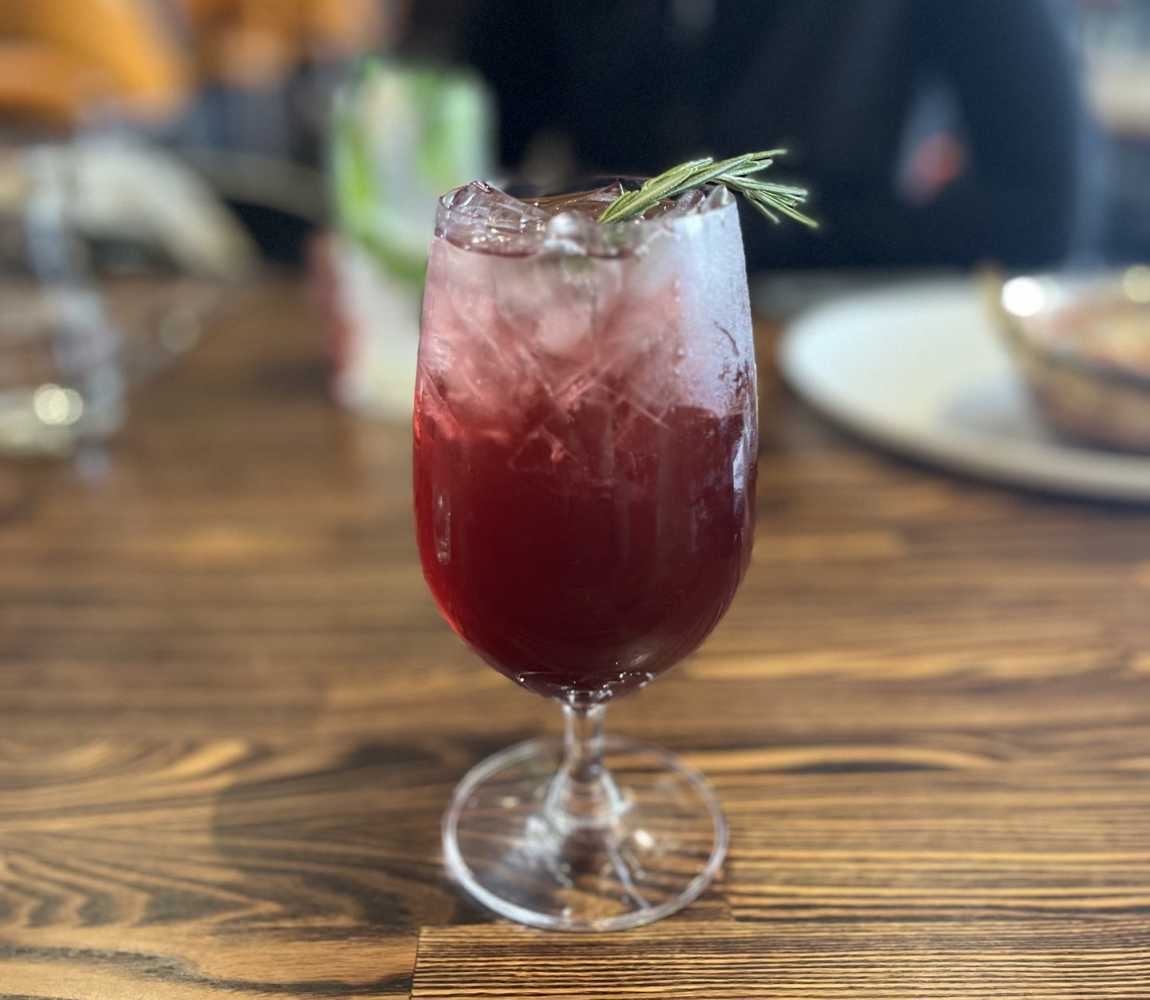 Cocktail drink with rosemary garnish at Romeo's Kitchen & Spirits in Kamloops.