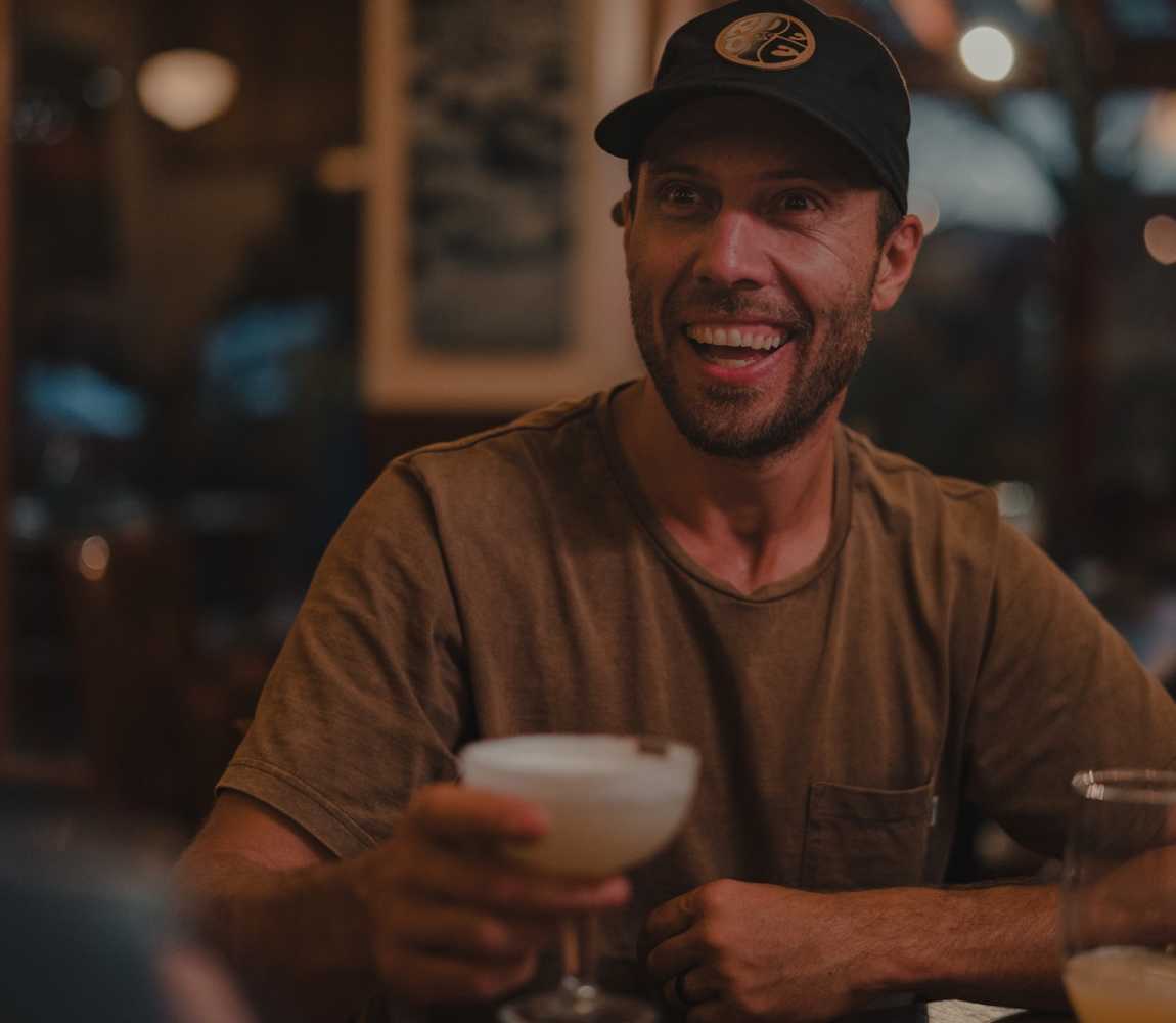 Happy customer cheers-ing their drink at Red Beard Cafe in Kamloops.