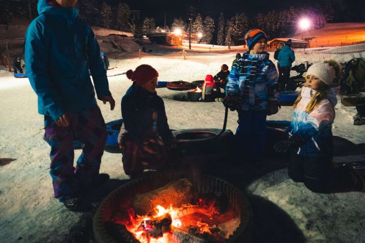 Warming up at the bonfire after night tubing at Harper Mountain