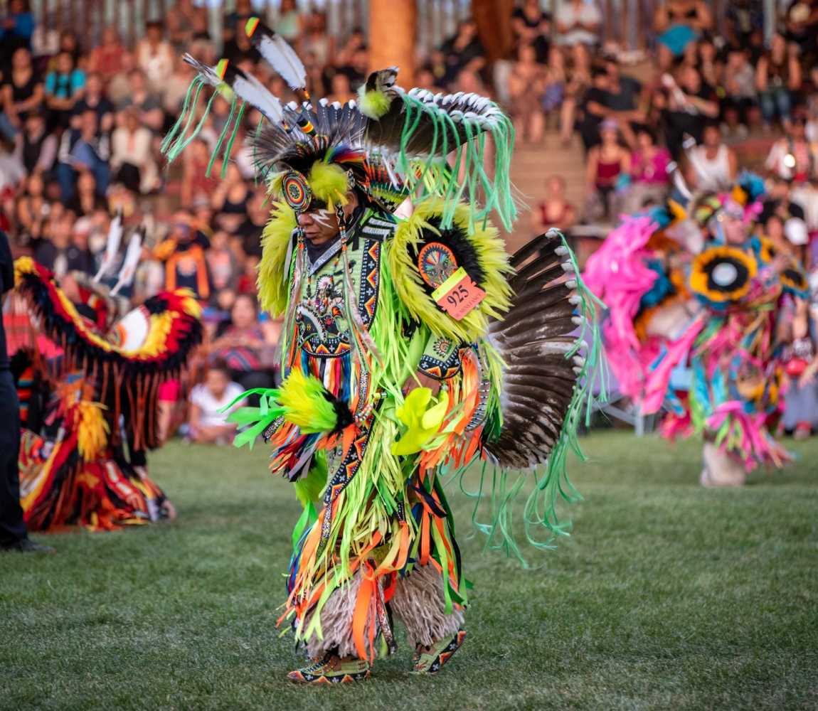 Dancer dressed in vibrant colours at the Kamloopa Powwow at the Special Events Facility (the Arbour) within Secwepemcúl’ecw, British Columbia.
