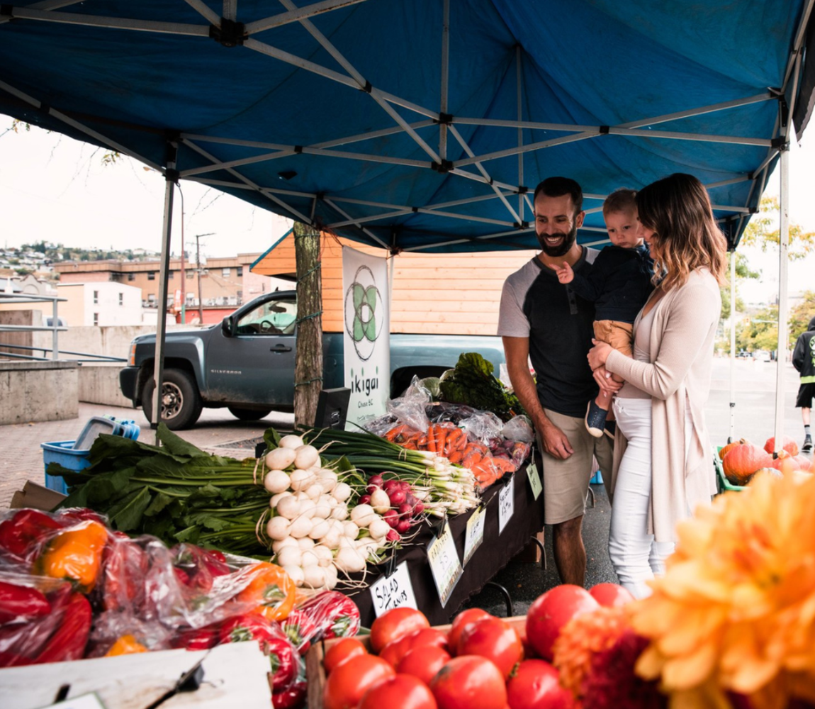 A family browsing the local produce at the Kamloops Farmers Market along St. Paul Street in Kamloops, BC.