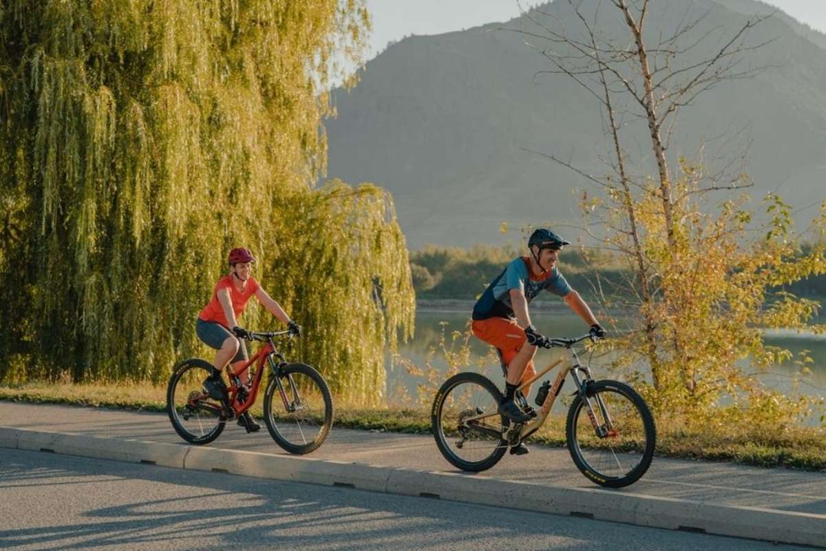 Couple biking along the Rivers Trail along Schubert Drive