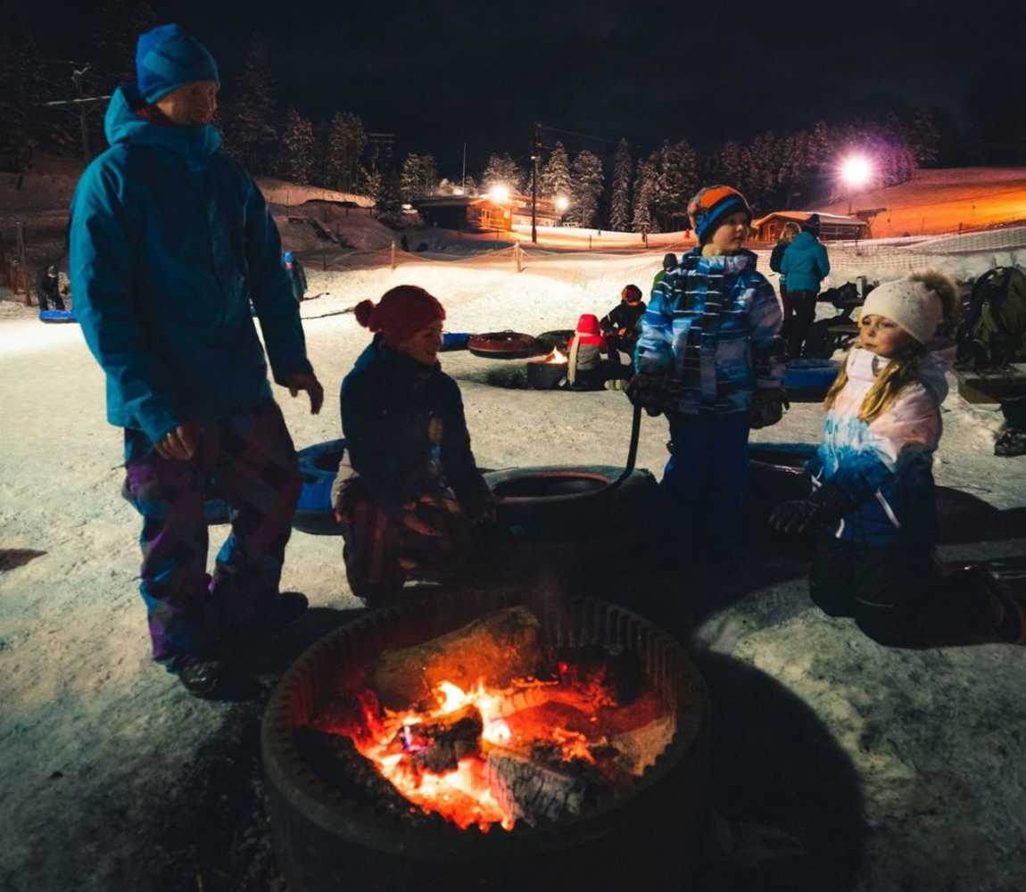 Warming up at the bonfire after night tubing at Harper Mountain