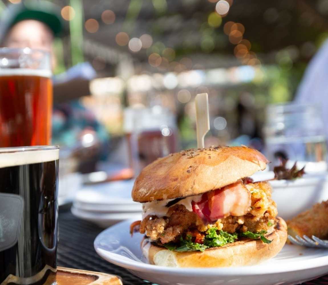 Burger and beer on a sunny patio at Noble Pig Brewhouse