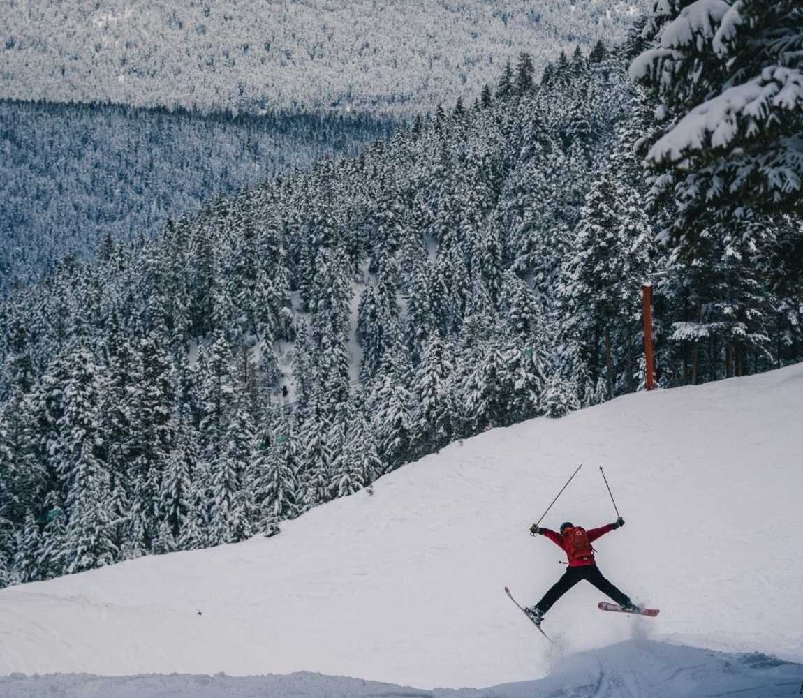 a person skiing off a jump at harper mountain near kamloops,bc