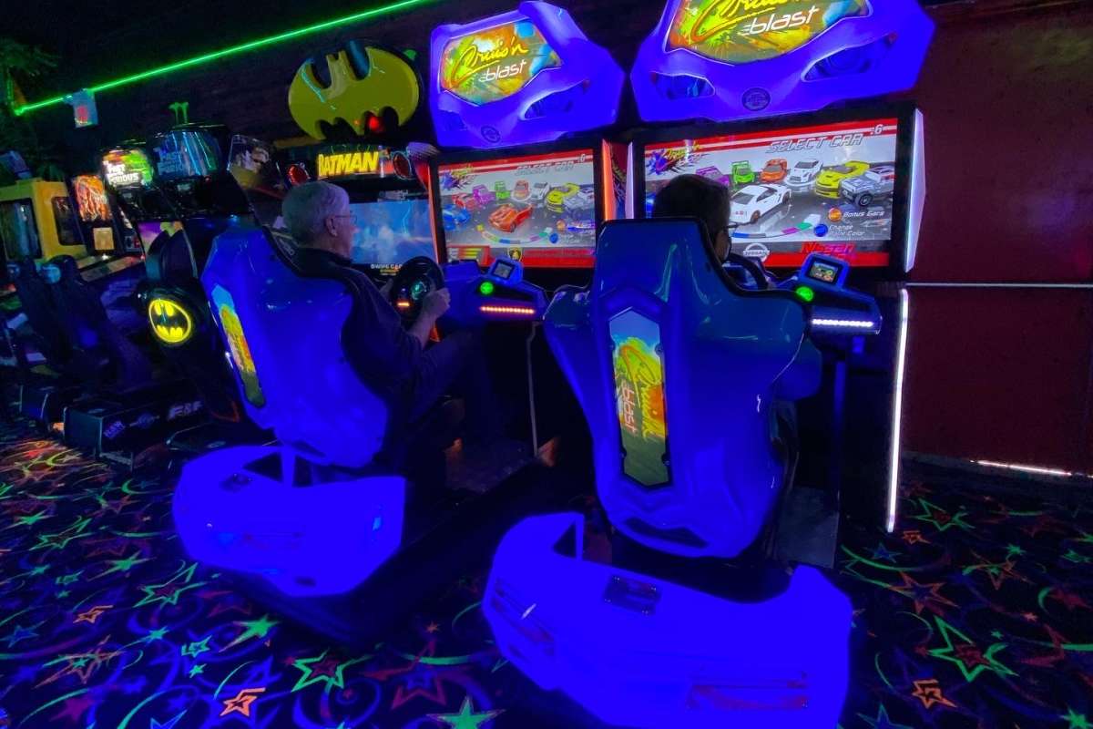 Two people playing a driving video game at the Fun Factor Fun Centre in Kamloops, BC.