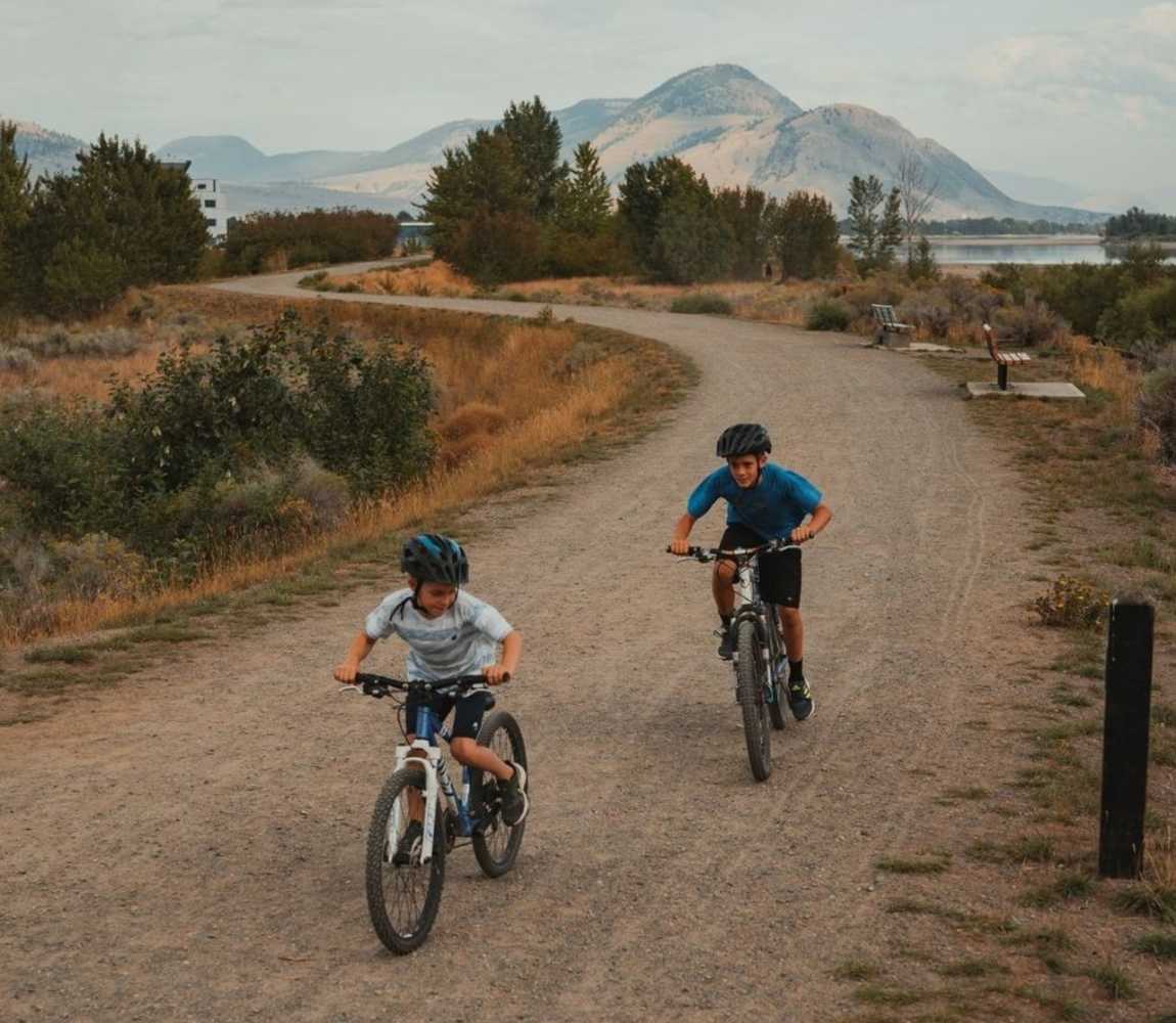 Kids biking along the Aviation Way section of the Rivers Trail in Kamloops