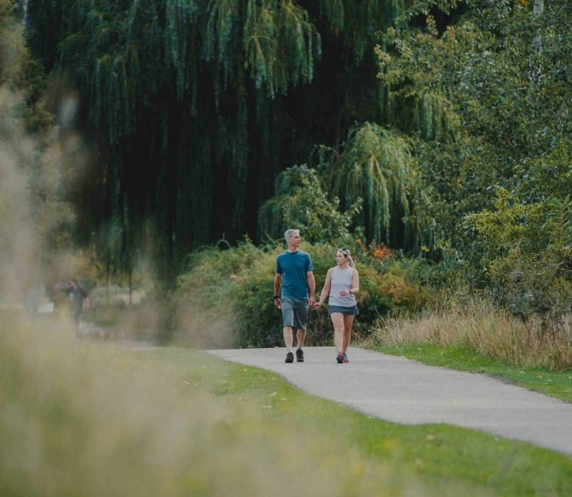 Couple walking along the Rivers Trail in McArthur Island