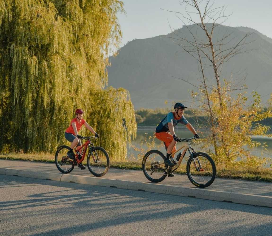 Couple biking along the Rivers Trail along Schubert Drive