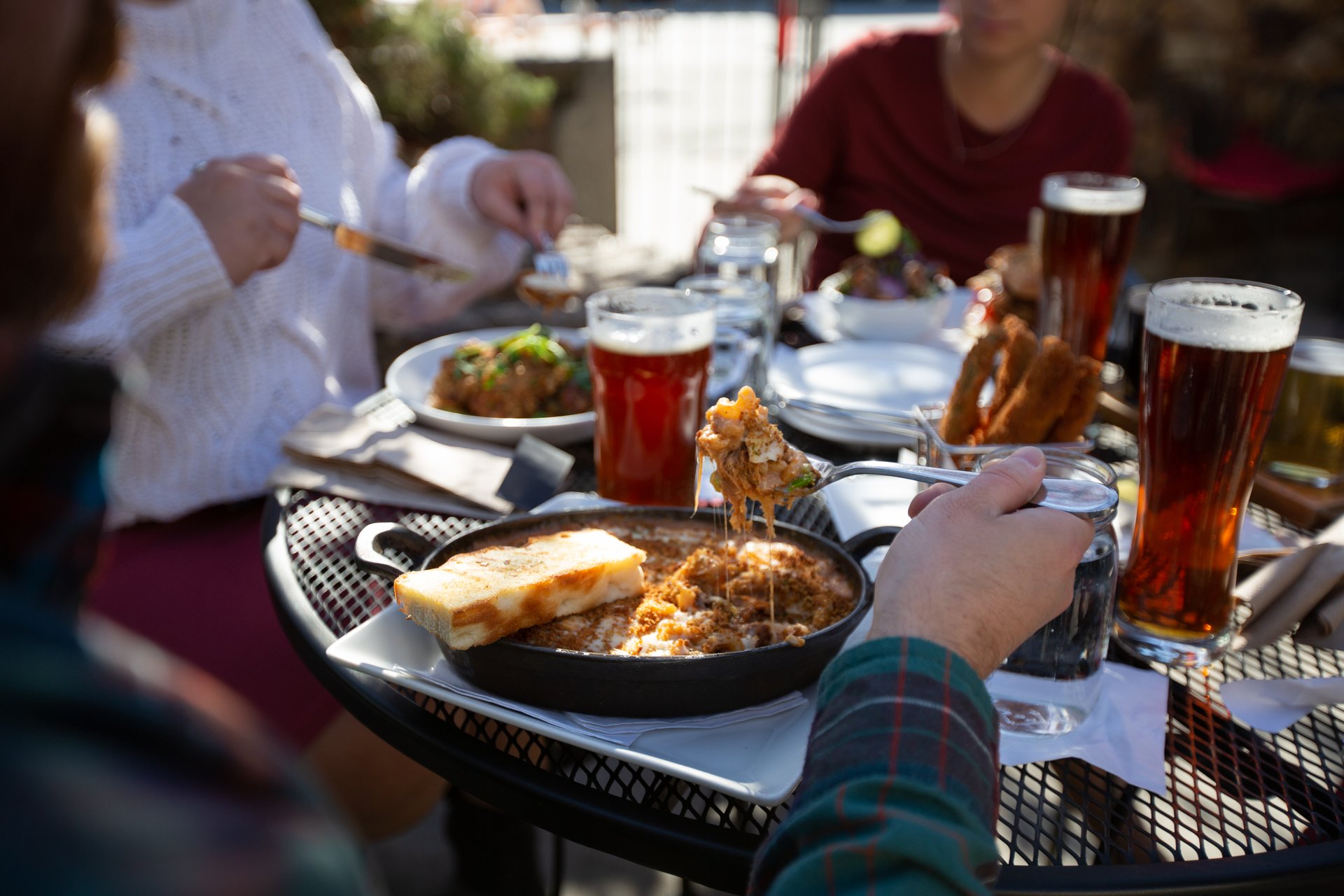 A group enjoying beer and food on the Noble Pig Patio located in downtown Kamloops, British Columbia.