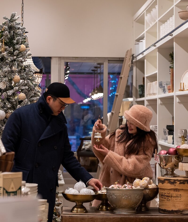 A couple Christmas shopping at Jardines Domaine shop located in downtown Kamloops, BC.