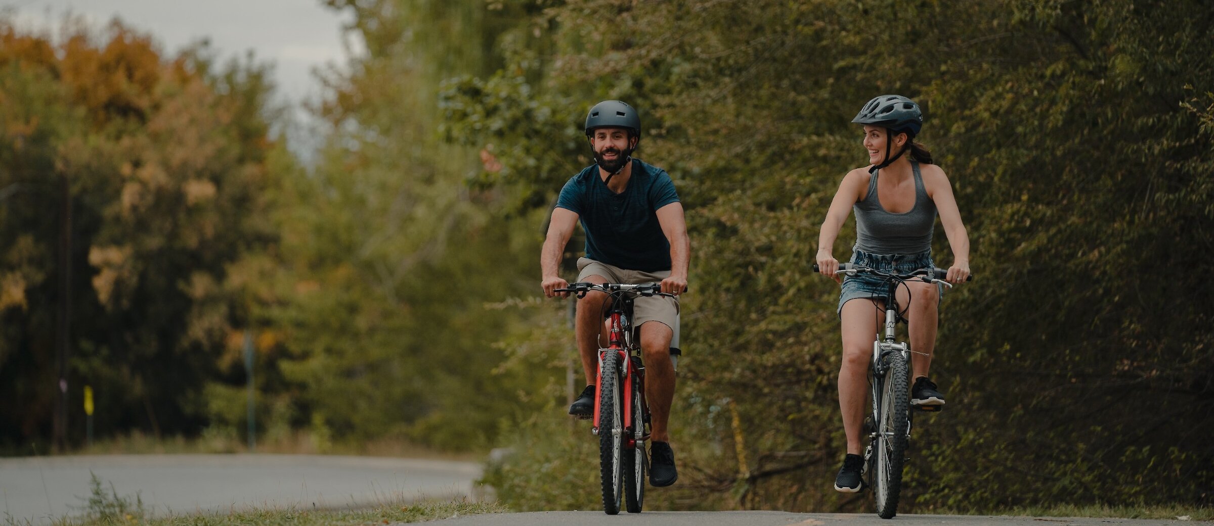 Couple biking along Rivers Trail in Kamloops, BC