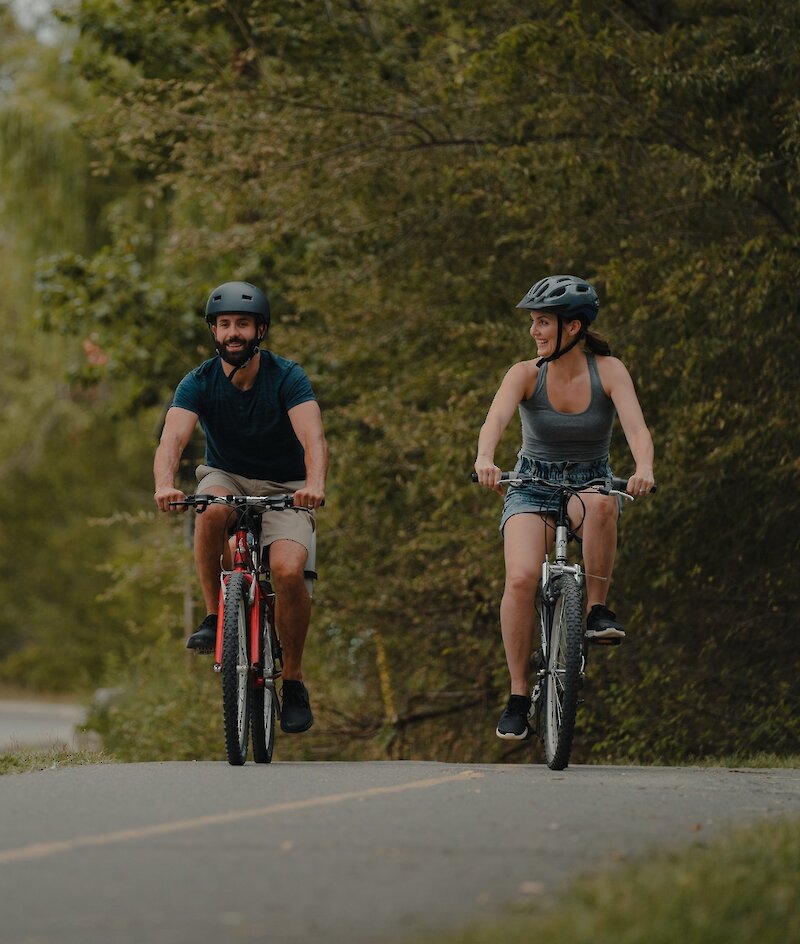 Couple biking along Rivers Trail in Kamloops, BC