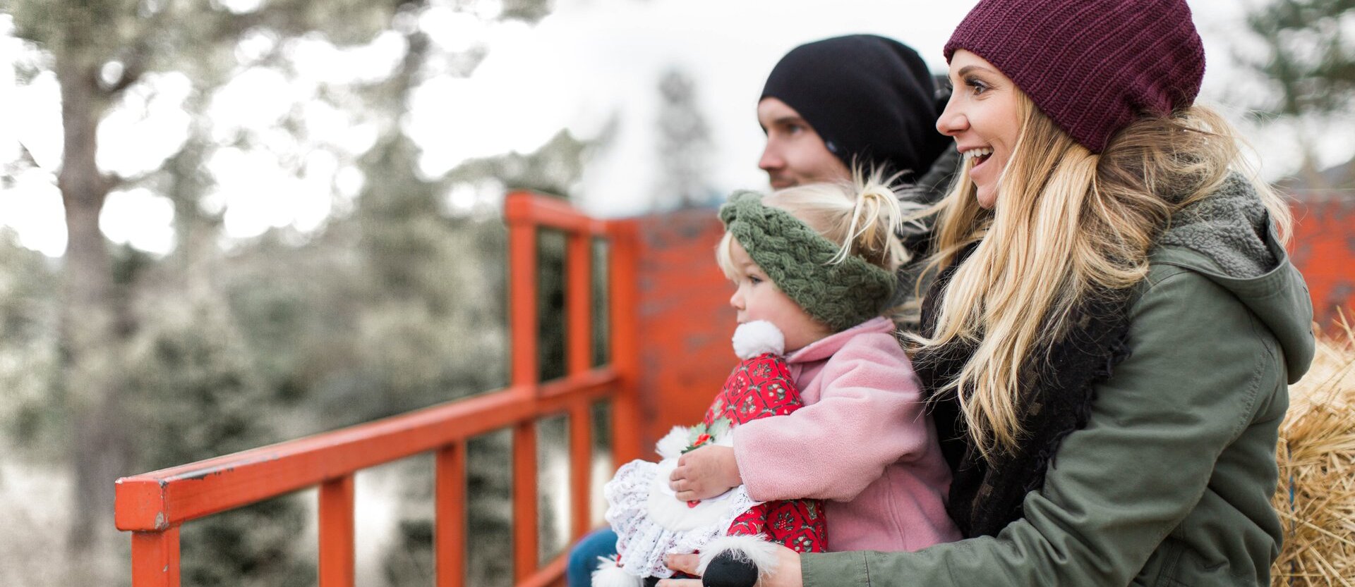 A family smiling on their tractor hayride at Privato Vineyard and Winery in Kamloops BC.