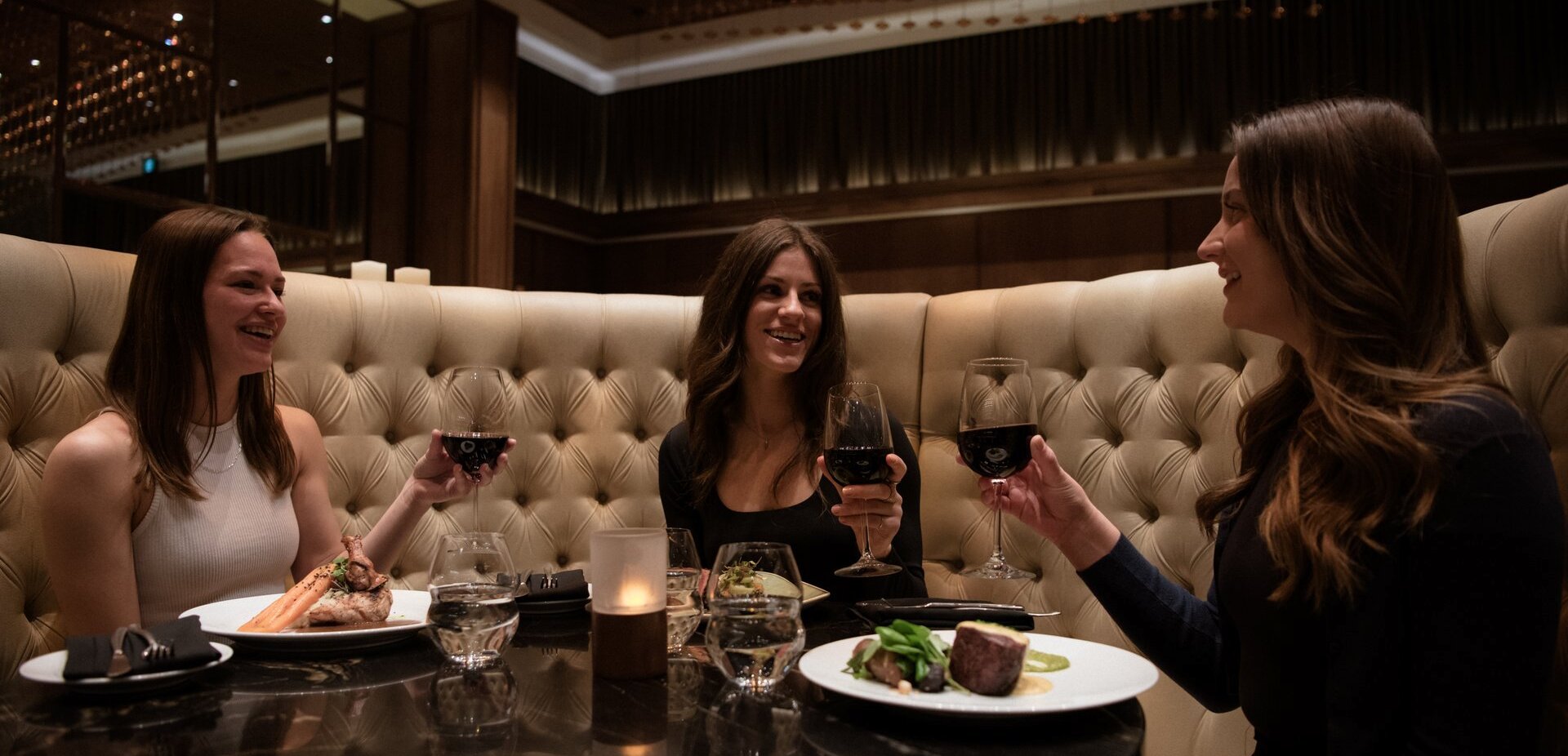 Three woman enjoying their meals at Atlas Steak + Fish during Taste Around in Kamloops, BC.