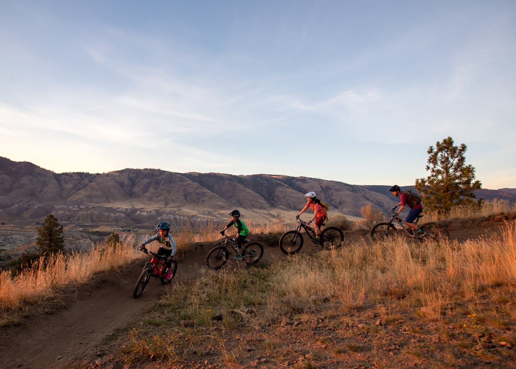 Two hikers looking out at the view from Kenna Cartwright Park over Kamloops Lake.