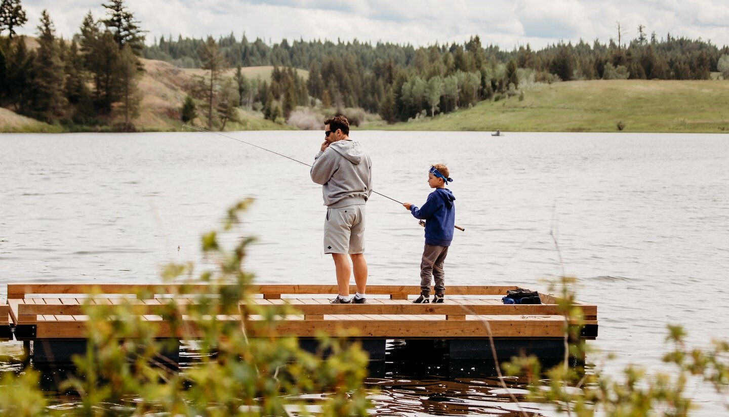A Father and son fishing off an accessible dock in Kamloops, BC.