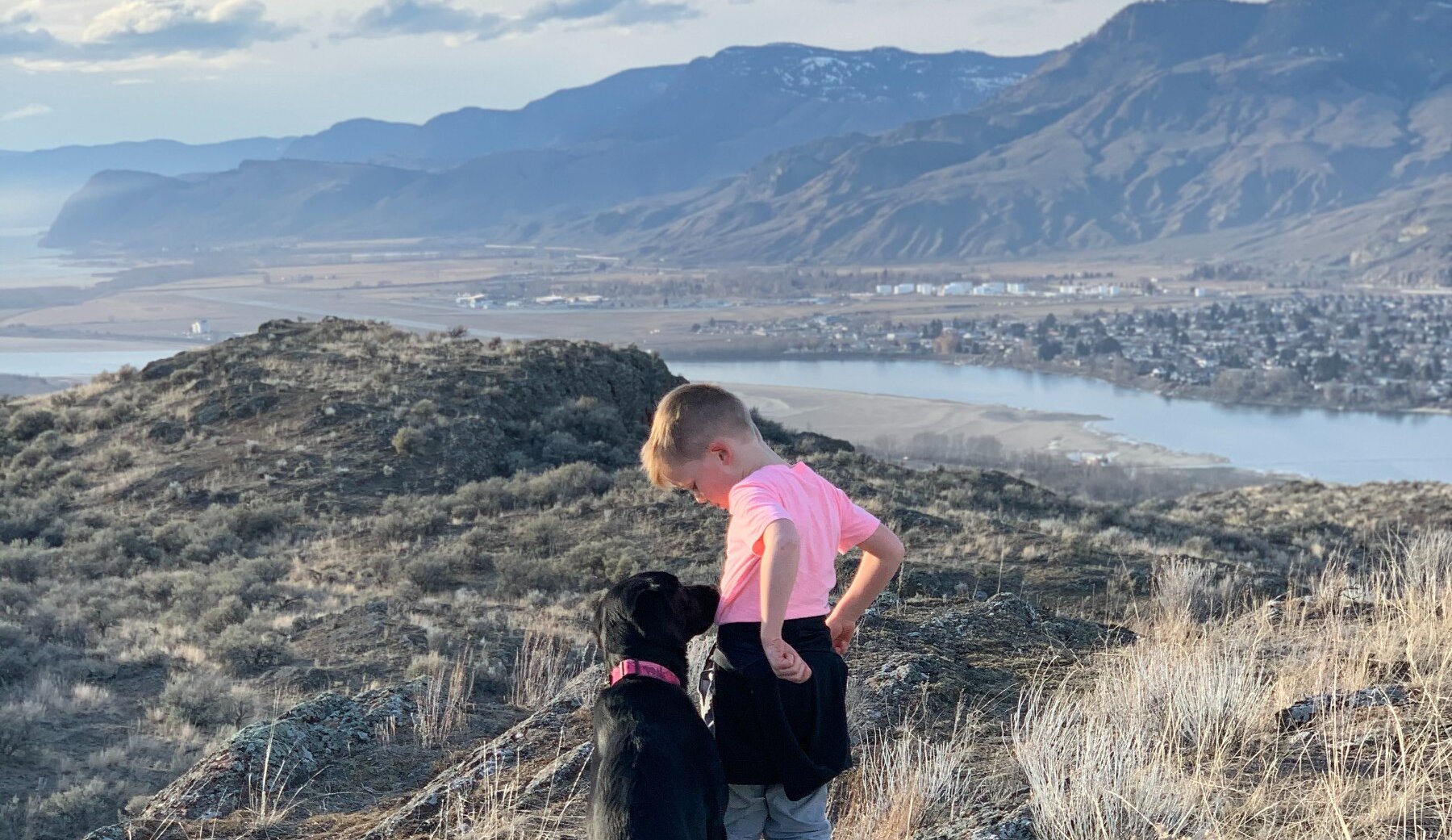 Boy celebrating his hike up Kenna Cartwright Park in Kamloops, BC.