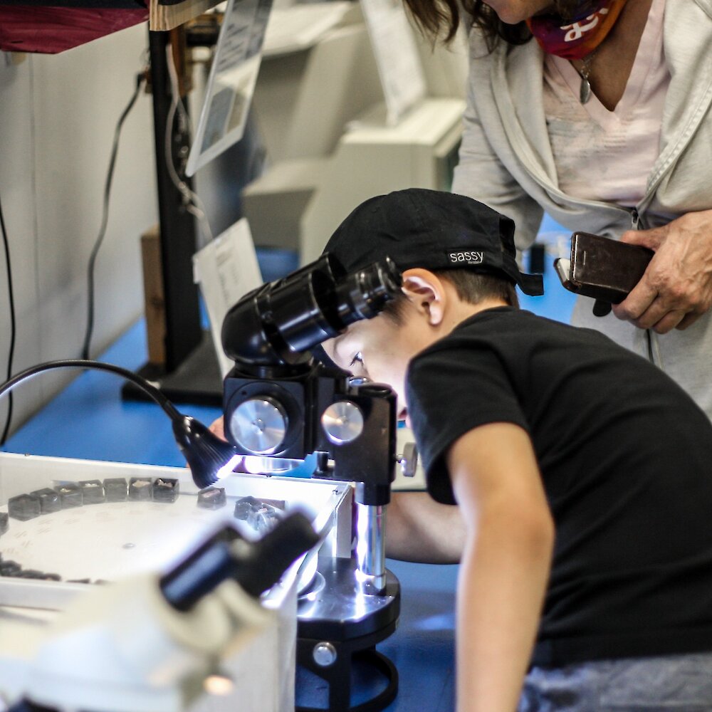 Boy using a microscope at the BIG Little Science Centre in Kamloops, BC.