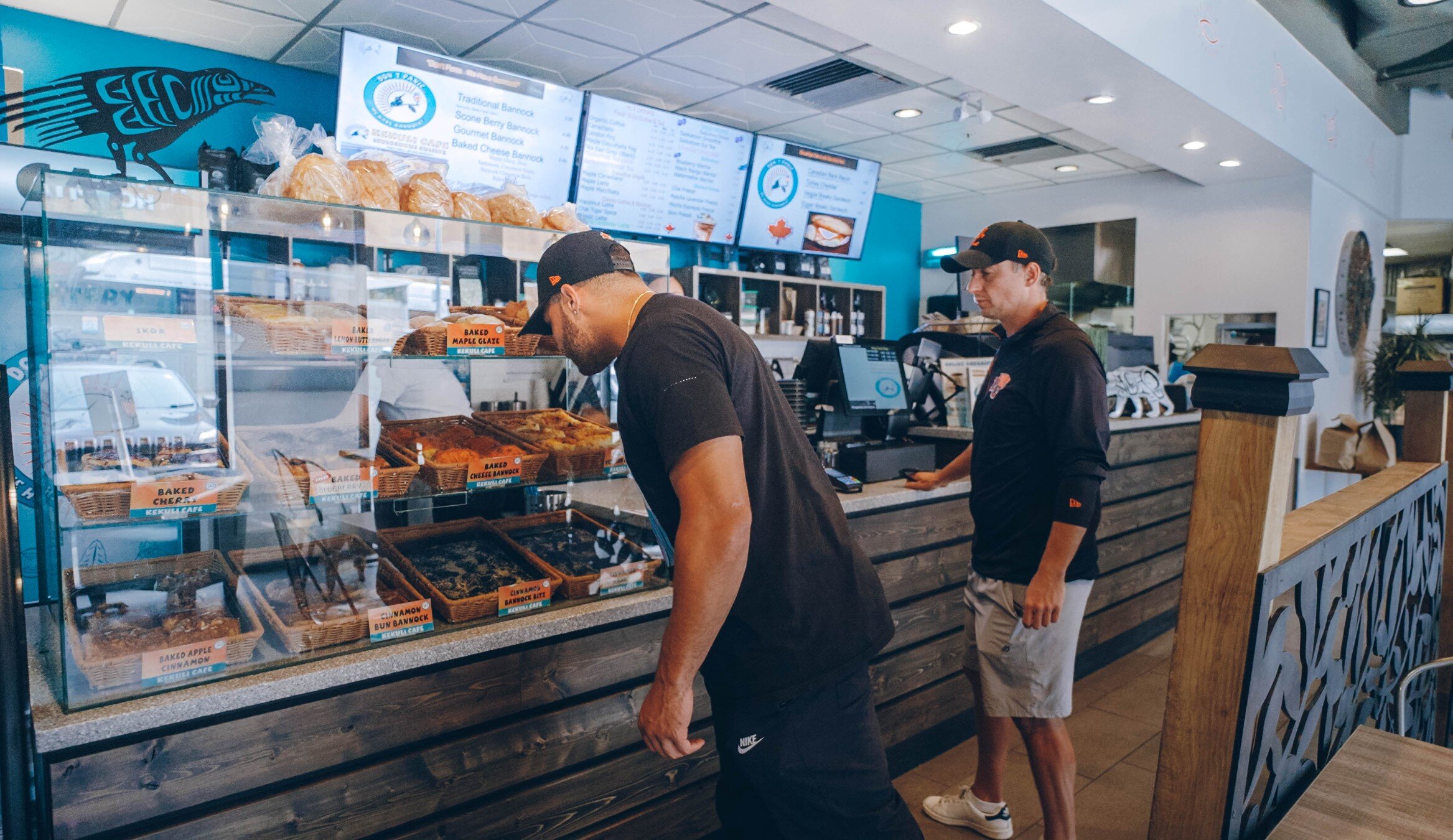 Two men choosing their bannock at the Kekuli Cafe in Kamloops, BC.