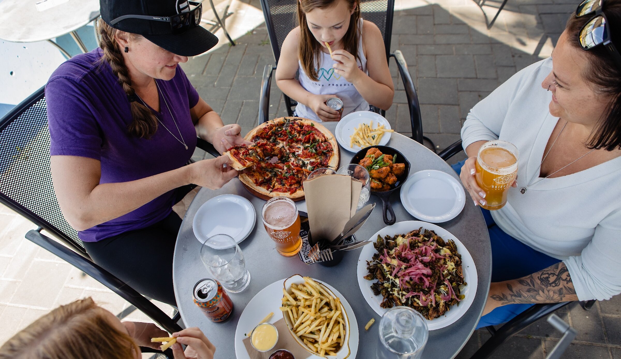 Family eating pizza on the patio at Bright Eye Brewing on the North Shore in Kamloops, BC.