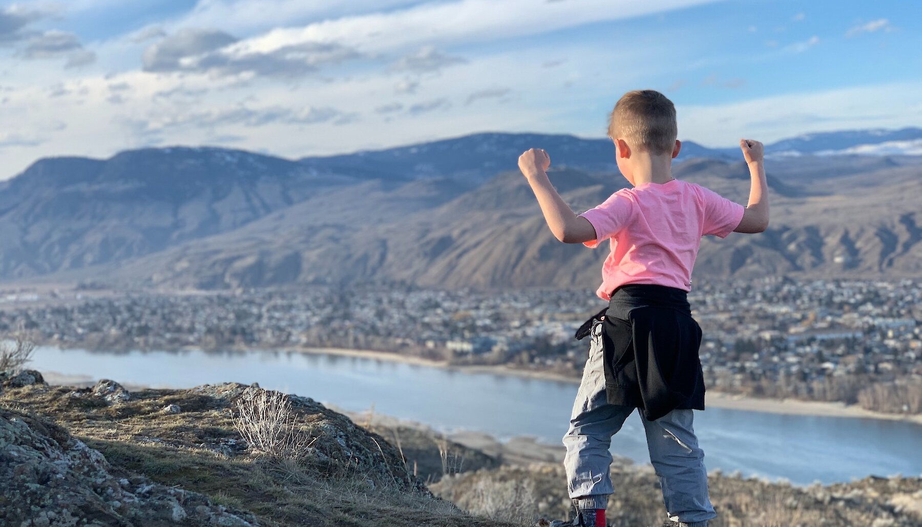 Boy celebrating his hike up Kenna Cartwright Park in Kamloops, BC.