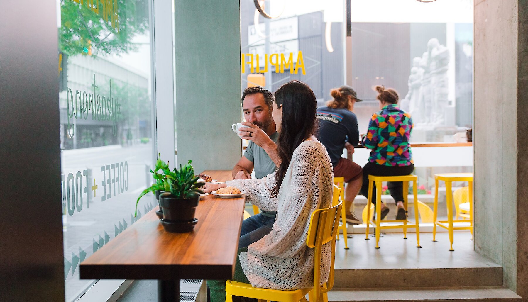 Couple drinking coffee at Amplified Cafe in downtown Kamloops, BC.