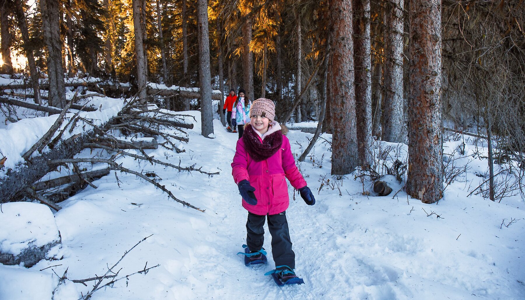 Family snowshoeing along the trail at Stake Lake near Kamloops, BC.