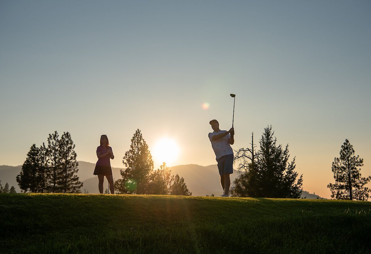 Golfers tee off at sunset on one of Kamloops golf courses.