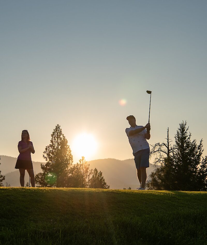 Golfers tee off at sunset on one of Kamloops golf courses.