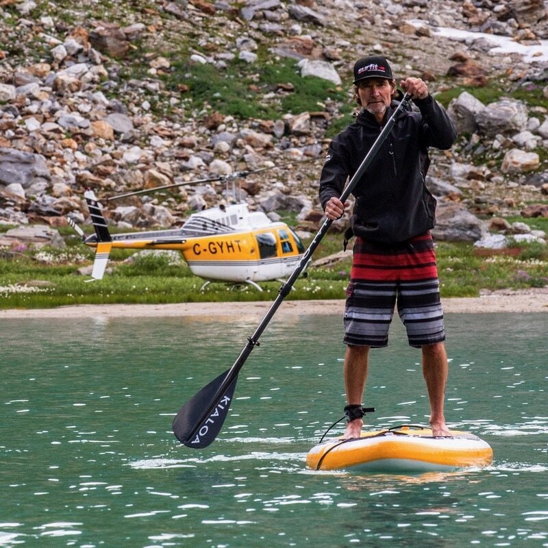 Bodie Shandro paddling with on a remote picturesque blue lake in BC.