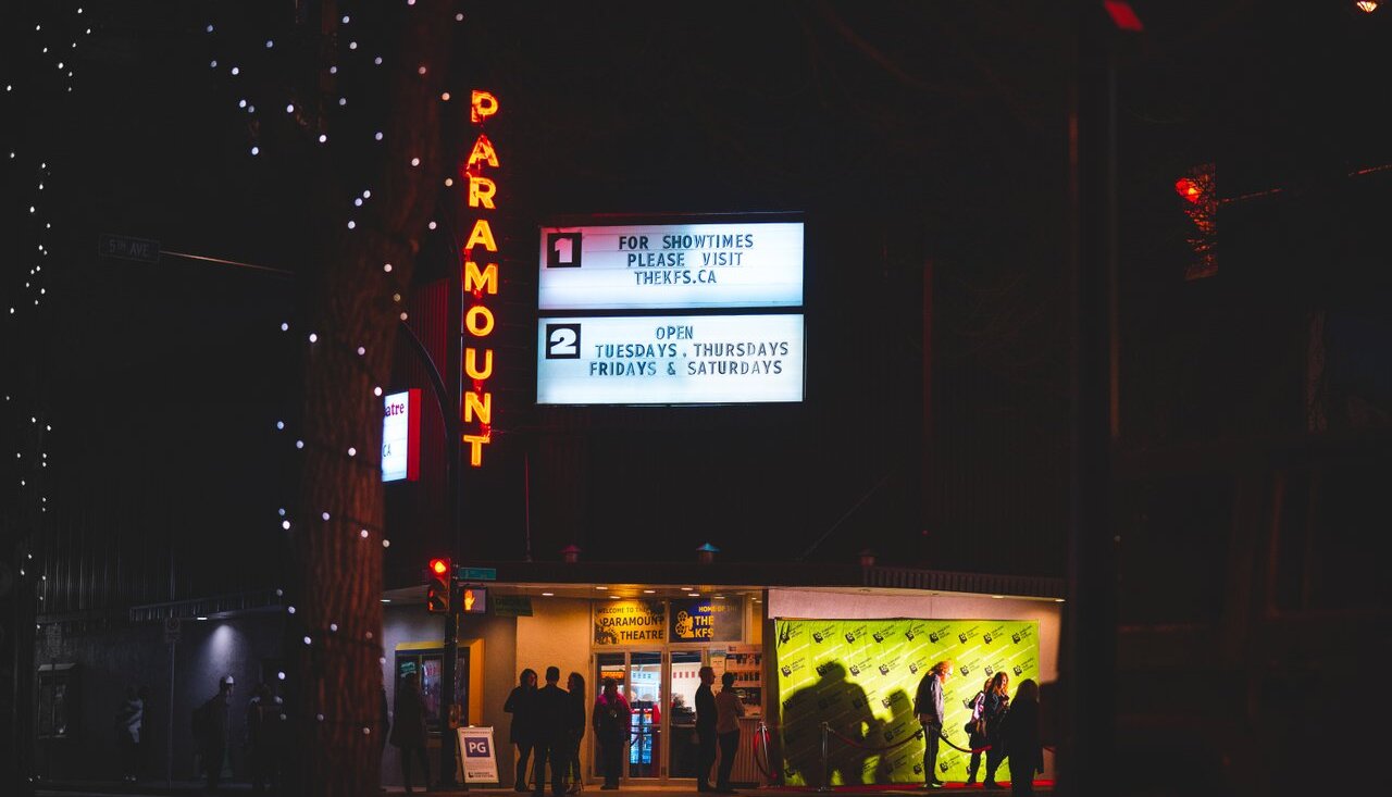 The Paramount Theatre in Kamloops BC is seen lit up at night.