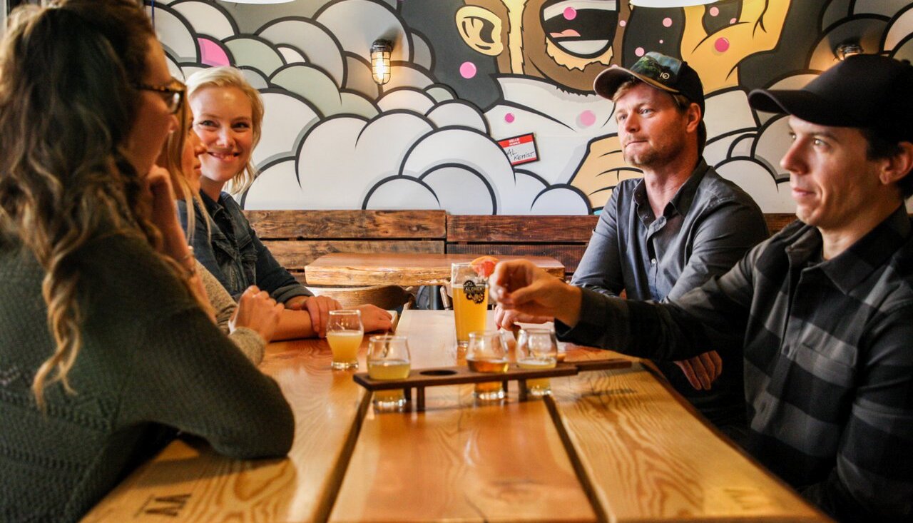 A group toasts glasses at Kamloops' Alchemy Brewing Co.