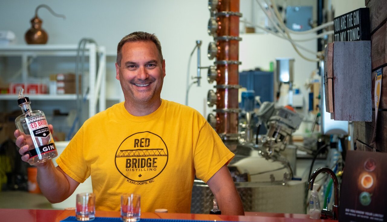 A man displays Red Bridge Gin at the distillery in Kamloops BC.